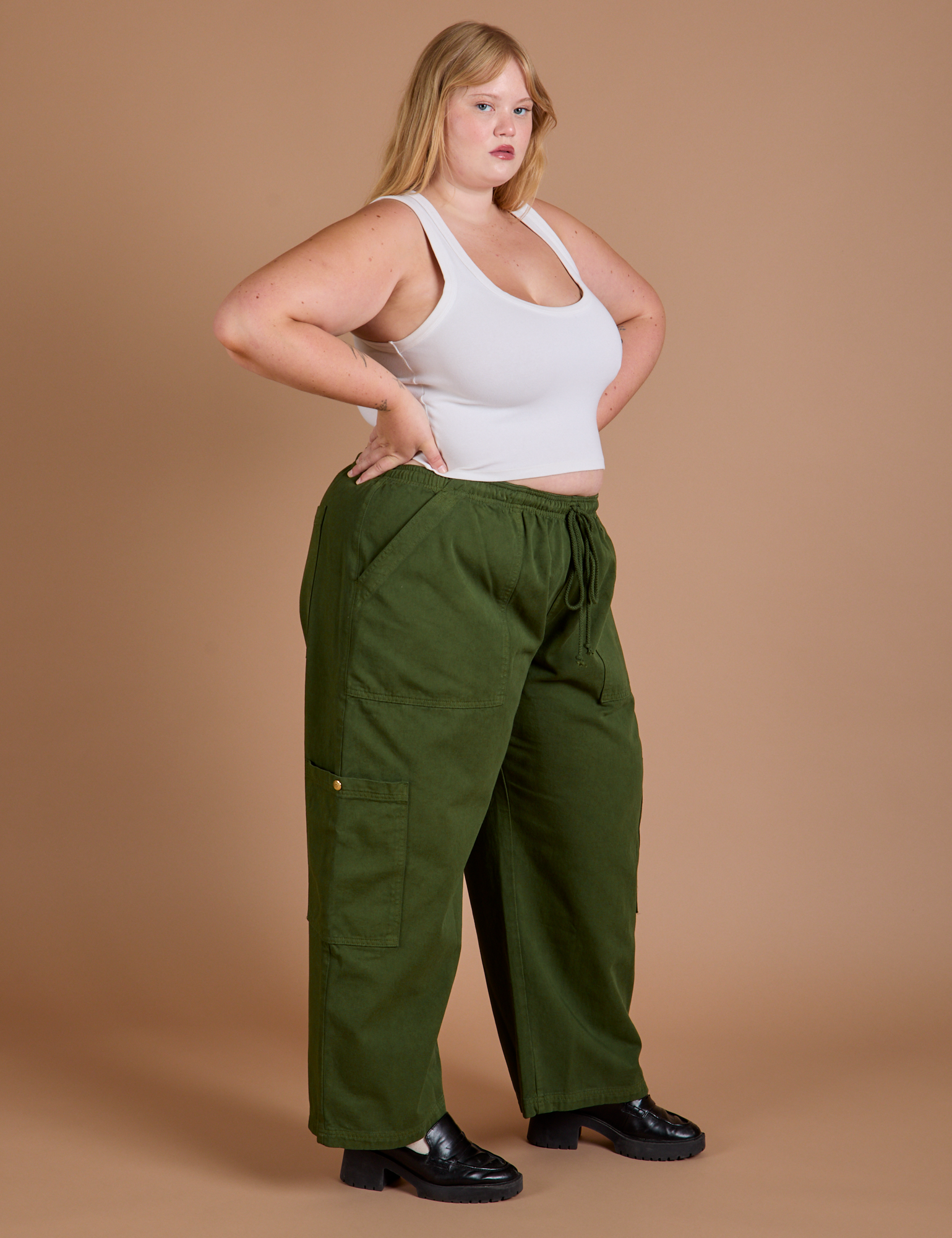 Side view of Drop Pocket Cargo Pants in Evergreen and Cropped Tank in vintage tee white