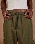 Drop Pocket Cargo Pants in Surplus Green front close up with Jerrod holding the cotton drawstring