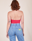 Back view of Halter Top in Hot Pink and light wash Frontier Jeans worn by Alex
