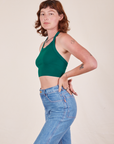 Side view of Halter Top in Hunter Green and light wash Frontier Jeans worn by Alex