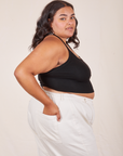 Side view of Halter Top in Basic Black and vintage off-white Western Pants worn by Alicia