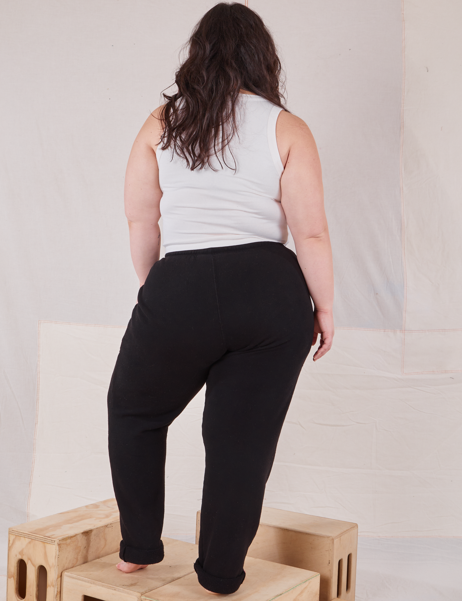 Back view of Rolled Cuff Sweat Pants in Basic Black and vintage off-white Cropped Tank on Ashley
