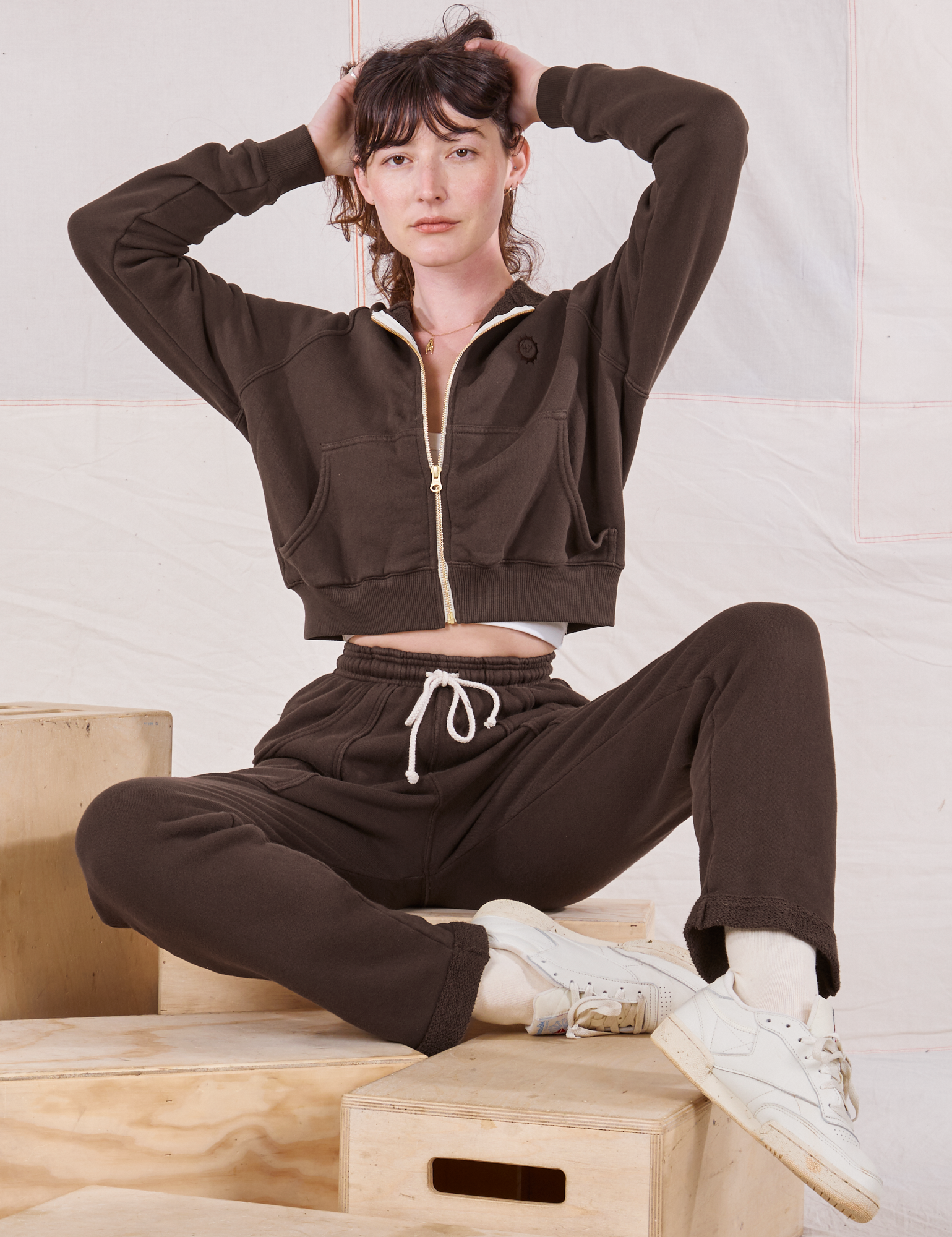 Alex is wearing Cropped Zip Hoodie in Espresso Brown and matching Rolled Cuff Sweat Pants
