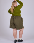Pleated Trouser Shorts in Surplus Green back view on Juliet