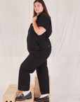 Heritage Short Sleeve Jumpsuit in Basic Black side view on Katie