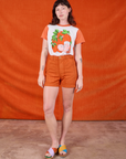 Alex is wearing Anniversary Tee in Orange Blossom
