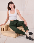 Alex is wearing Heritage Trousers in Swamp Green and Cropped Tank in vintage tee off-white