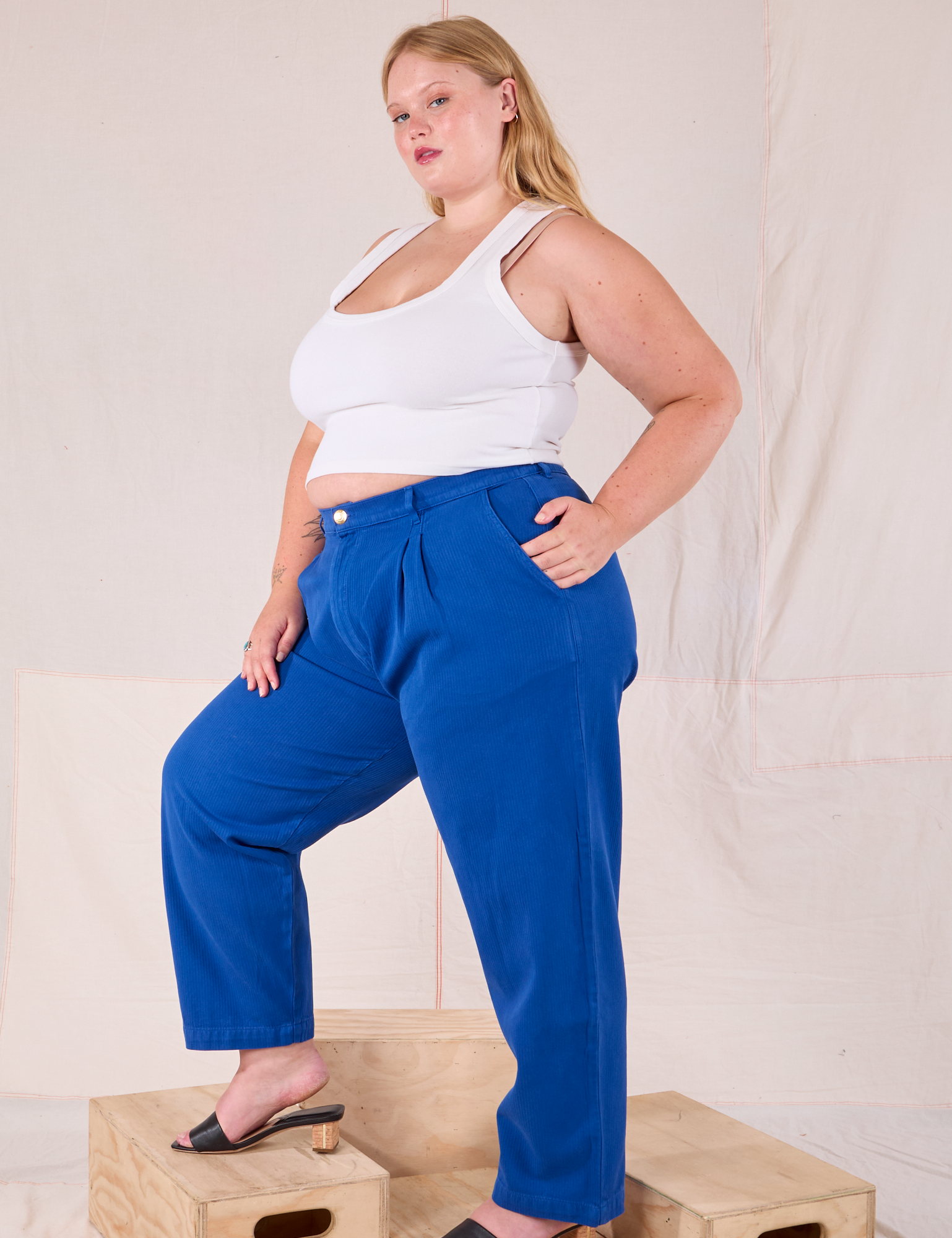 Side view of Heritage Trousers in Royal Blue and Cropped Tank in vintage tee off-white on Juliet