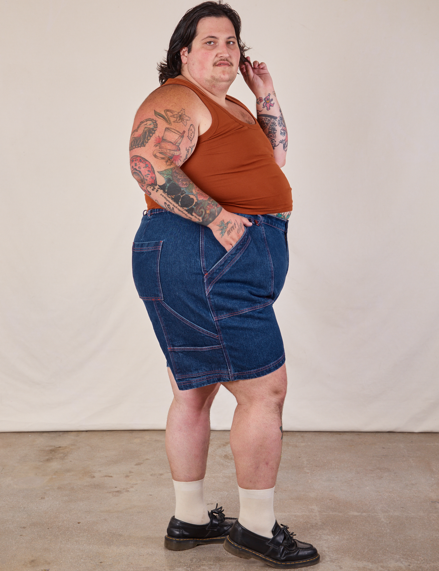 Side view of Carpenter Shorts in Dark Wash and burnt terracotta Cropped Tank on Sam