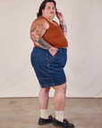Side view of Carpenter Shorts in Dark Wash and burnt terracotta Cropped Tank on Sam