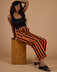 Black Stripe Work Pants in Construction Orange and black cropped tank on Kandia