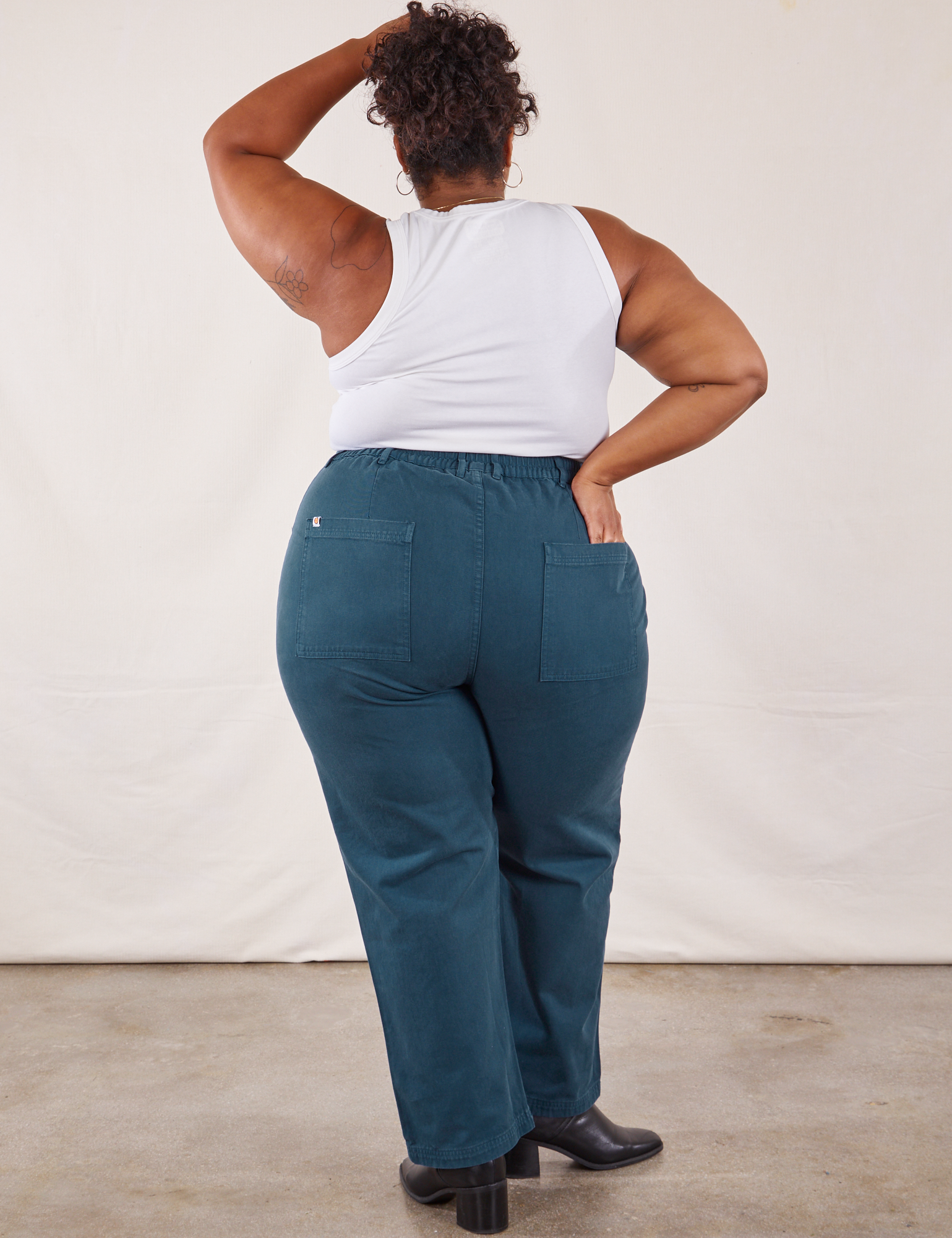 Back view of Work Pants in Lagoon and vintage tee off-white Tank Top on Morgan