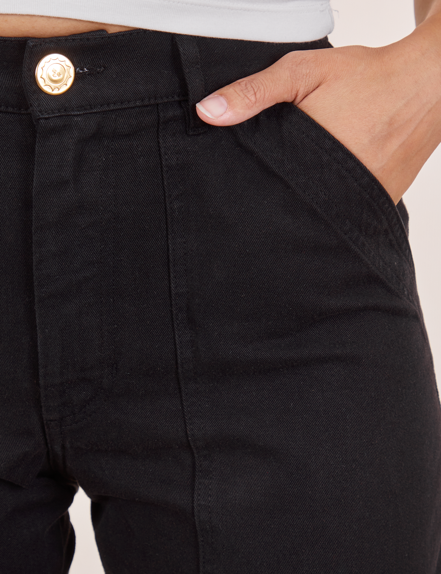 Pencil Pants in Basic Black front pocket close up. Alex has her hand in the pocket.