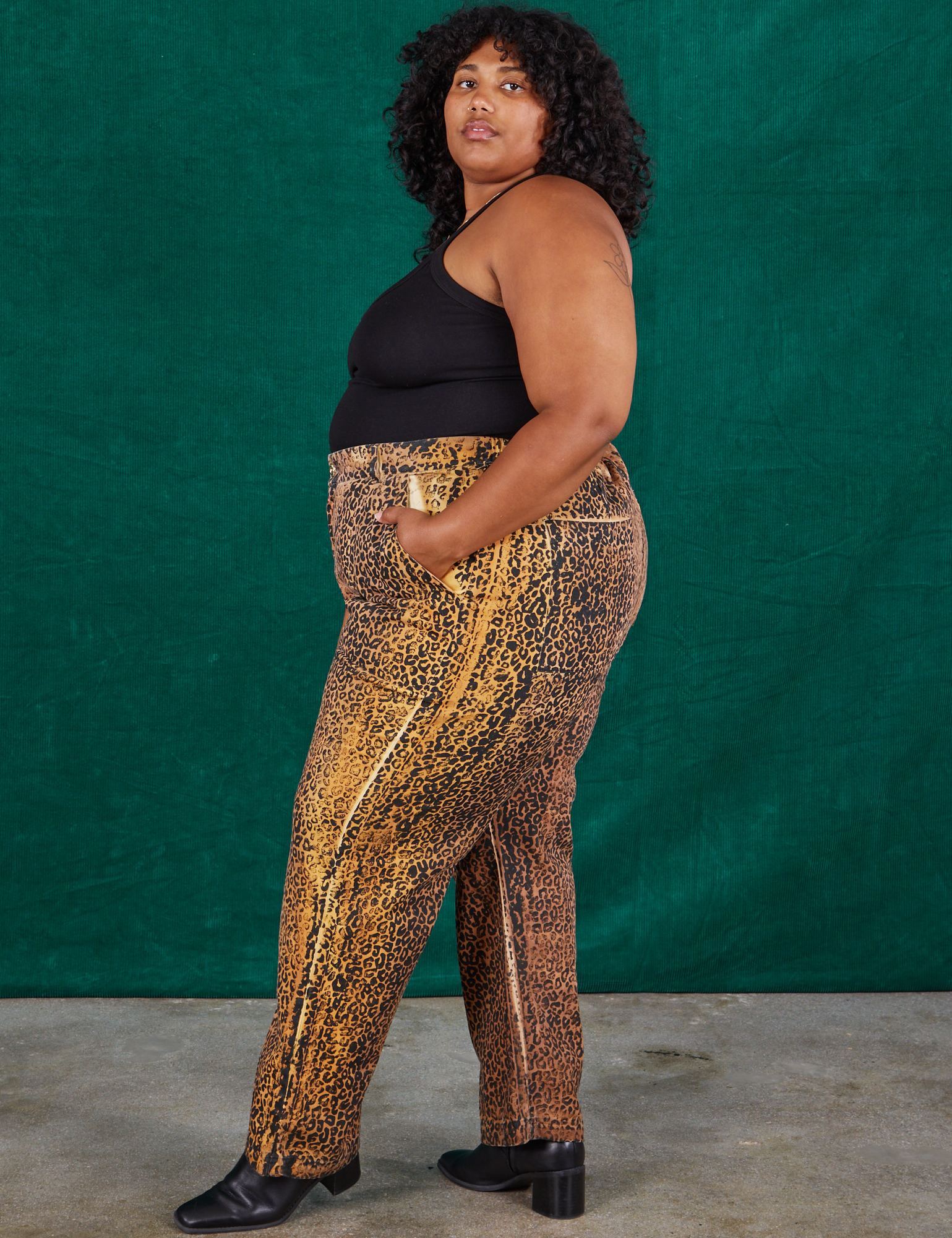Side view of Leopard Work Pants and black Halter Top on Morgan