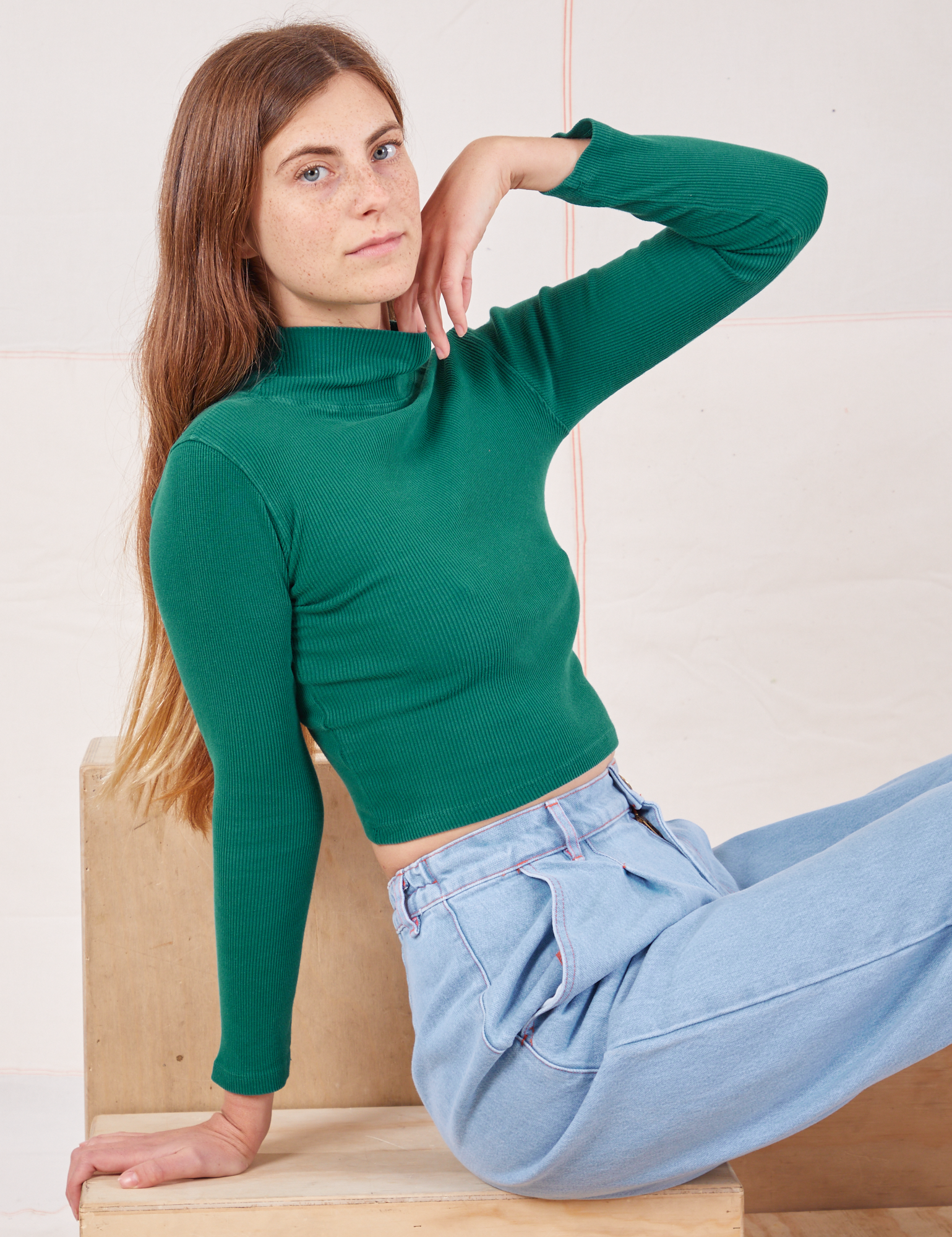 Essential Turtleneck in Hunter Green angled front view on Scarlett