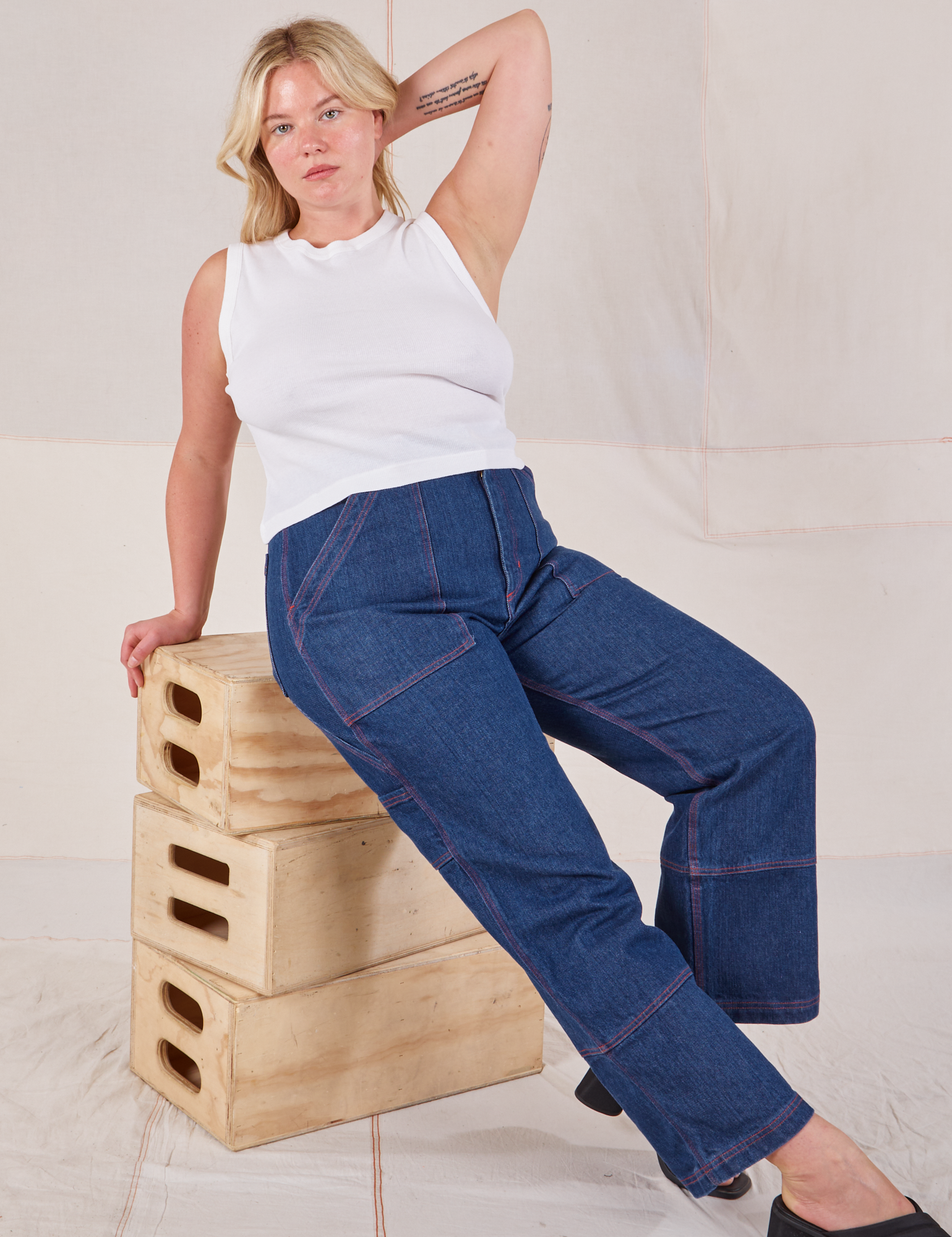 Lish is wearing Muscle Tee in Vintage Tee Off-White and dark wash Carpenter Jeans