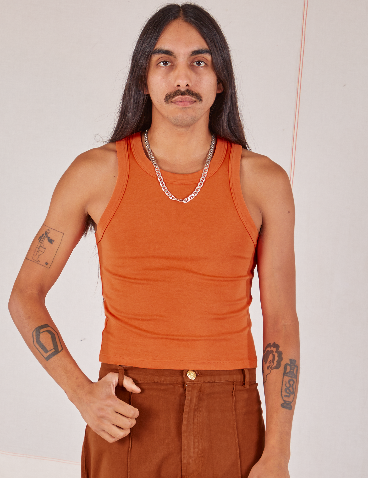 Anthony is 5’10” and wearing S Racerback Tank in Sunset Orange