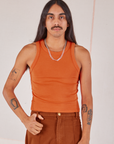 Anthony is 5’10” and wearing S Racerback Tank in Sunset Orange