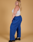 Side view of Baggy Mid-Rise Trousers in Royal Blue and vintage tee white Cropped Tank on Juliet