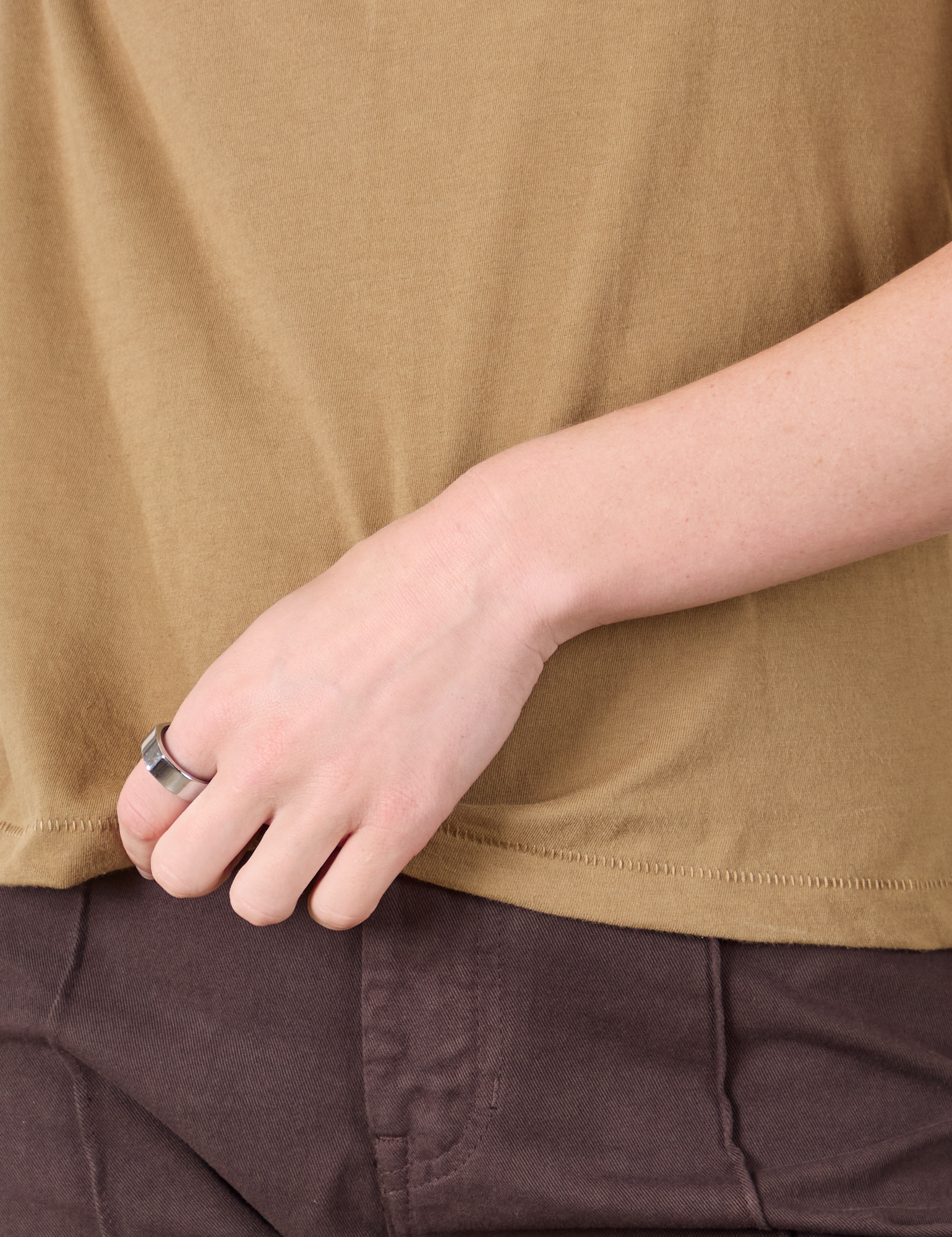 Mismatched Tee in Tan & Brown bottom hem close up on Alex