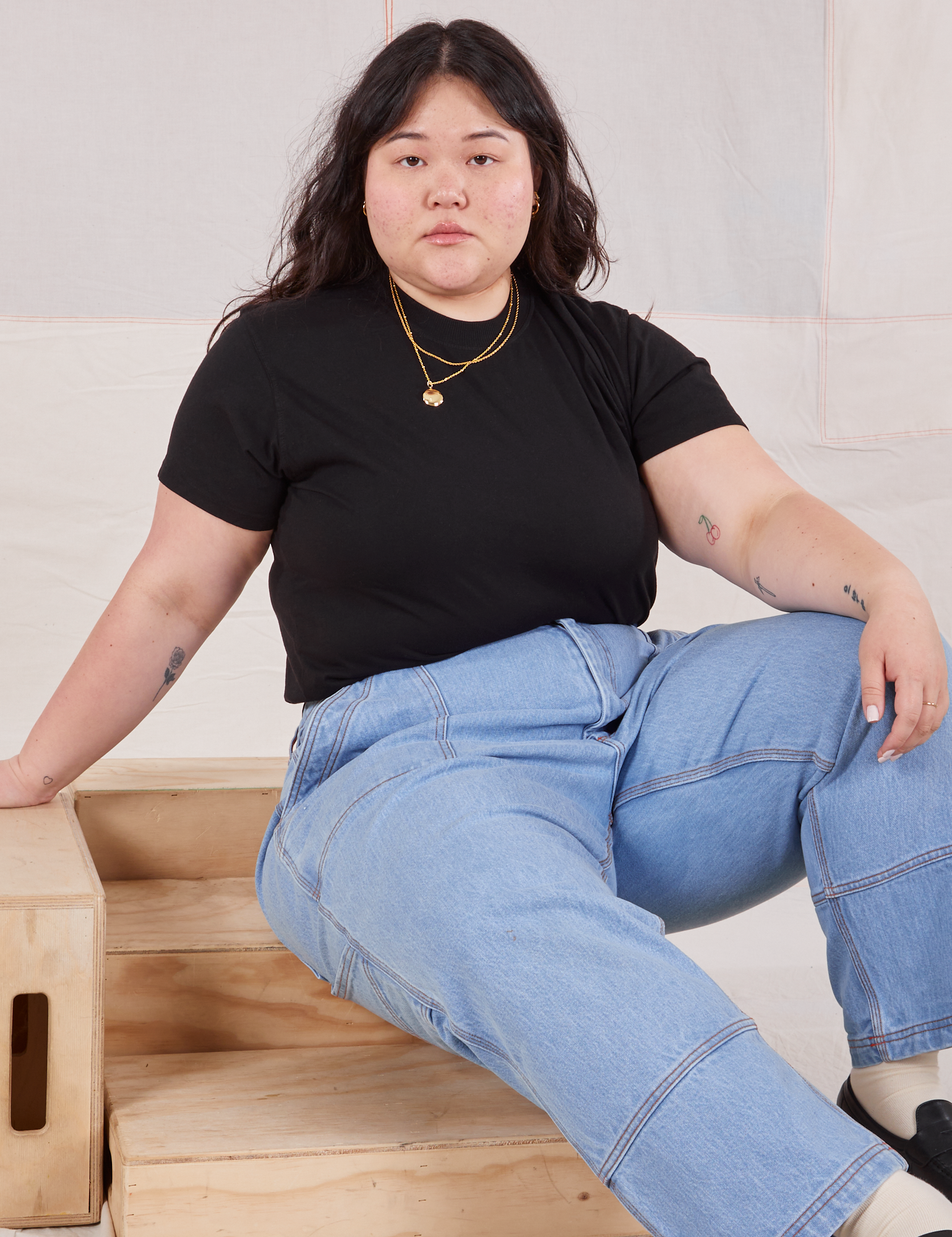 Ashley is wearing Organic Vintage Tee in Basic Black and light wash Carpenter Jeans