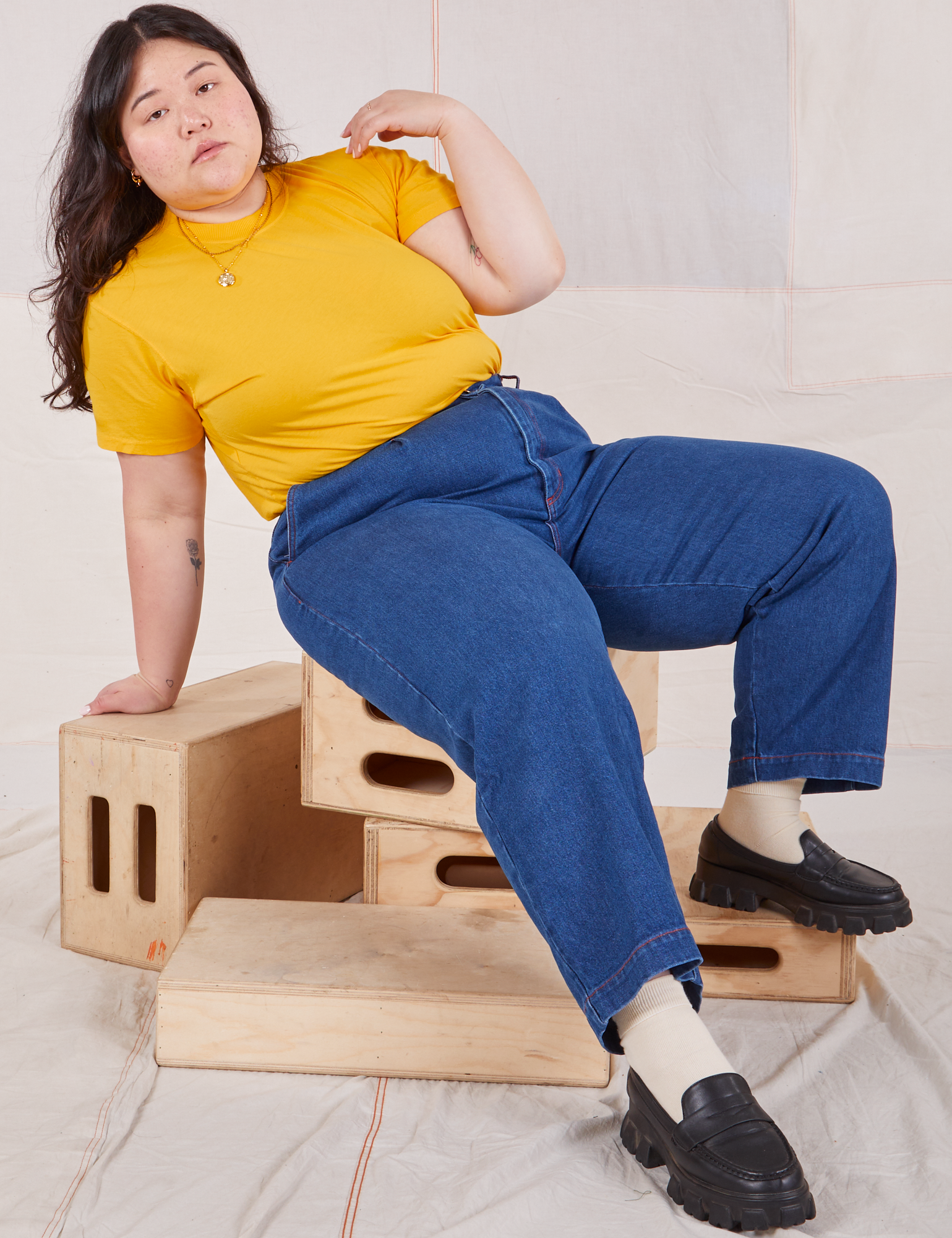Ashley is wearing Organic Vintage Tee in Sunshine Yellow and dark wash Trouser Jeans