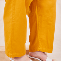 Bottom pant leg close up of Organic Trousers in Mustard Yellow worn by Ashley