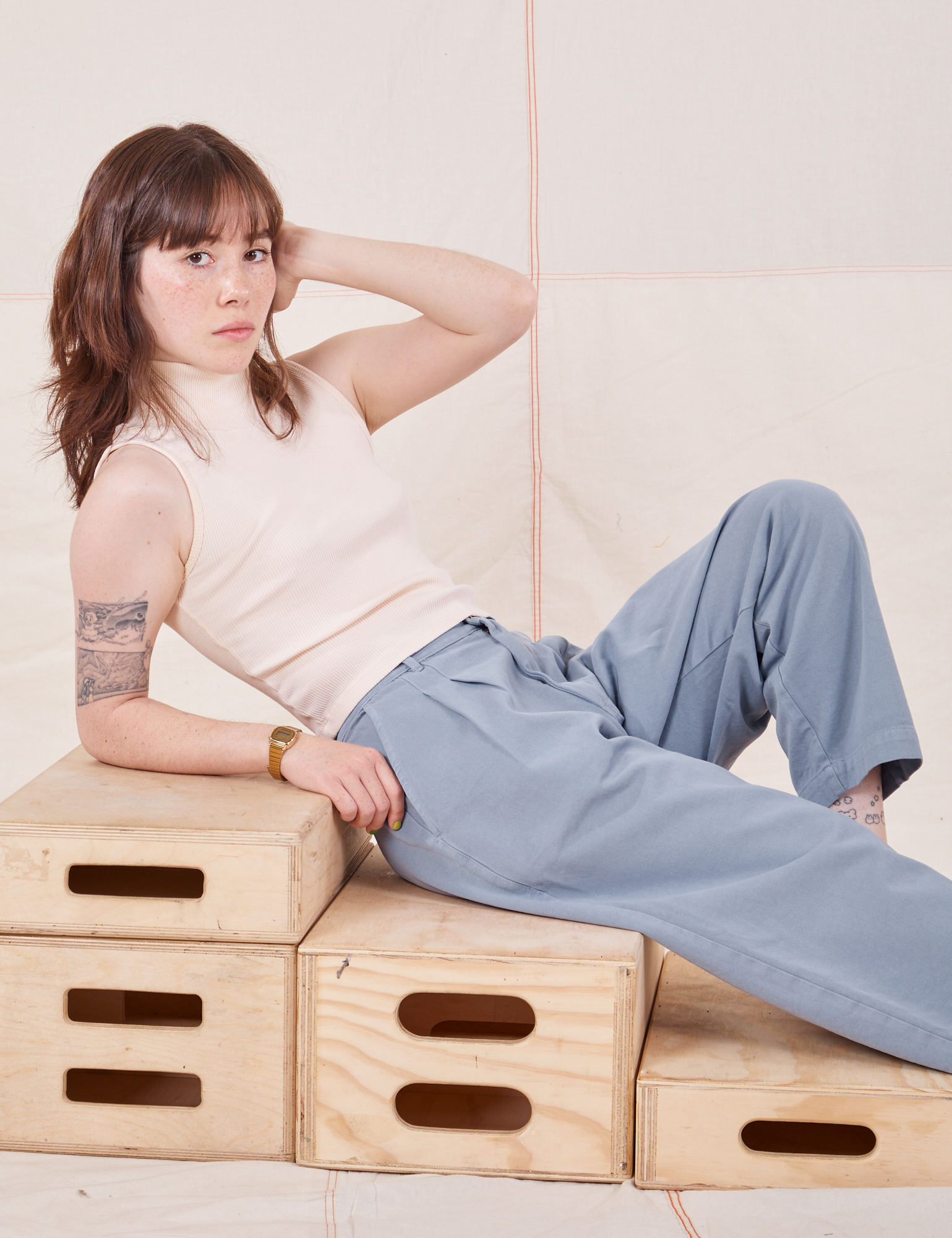 Hana is wearing Organic Trousers in Periwinkle and Sleeveless Turtleneck in vintage tee off-white