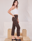 Side view of Railroad Carpenter Jeans in Fudgesicle Brown and vintage tee off-white Square Neck Tank on Alex