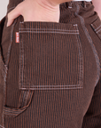 Close up of Alex's hand in the back pocket of Railroad Carpenter Shorts in Fudgesicle Brown