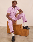 Issac is wearing Short Sleeve Jumpsuit in Lilac