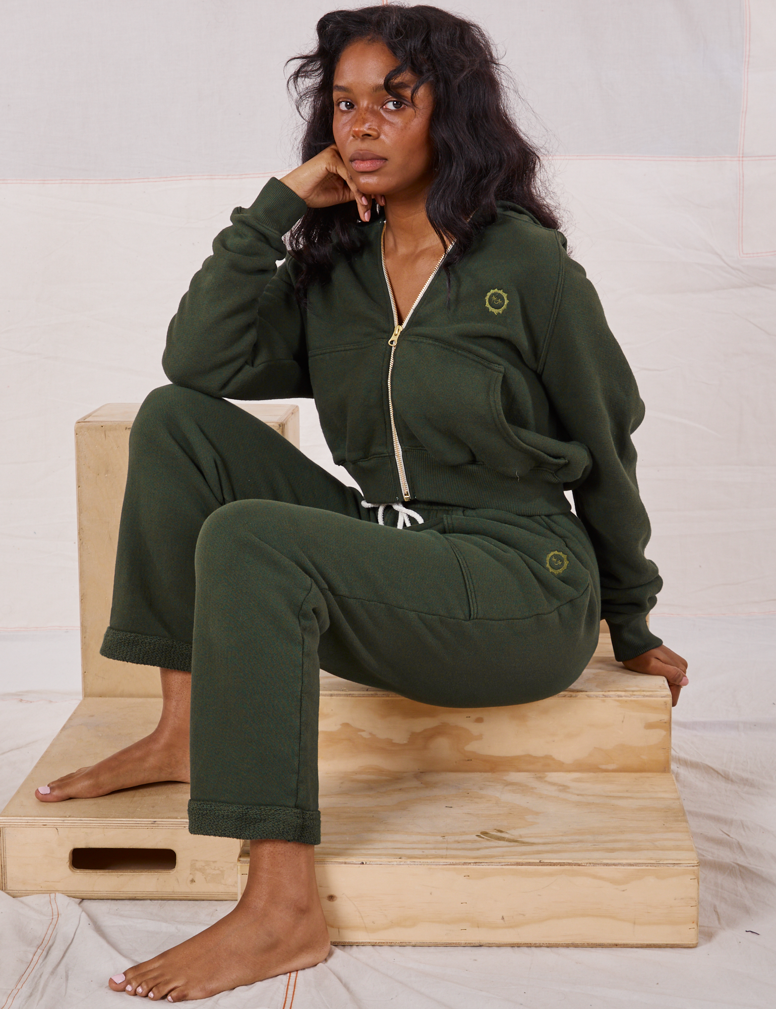 Kandia is wearing Rolled Cuff Sweat Pants in Swamp Green and matching Cropped Zip Hoodie