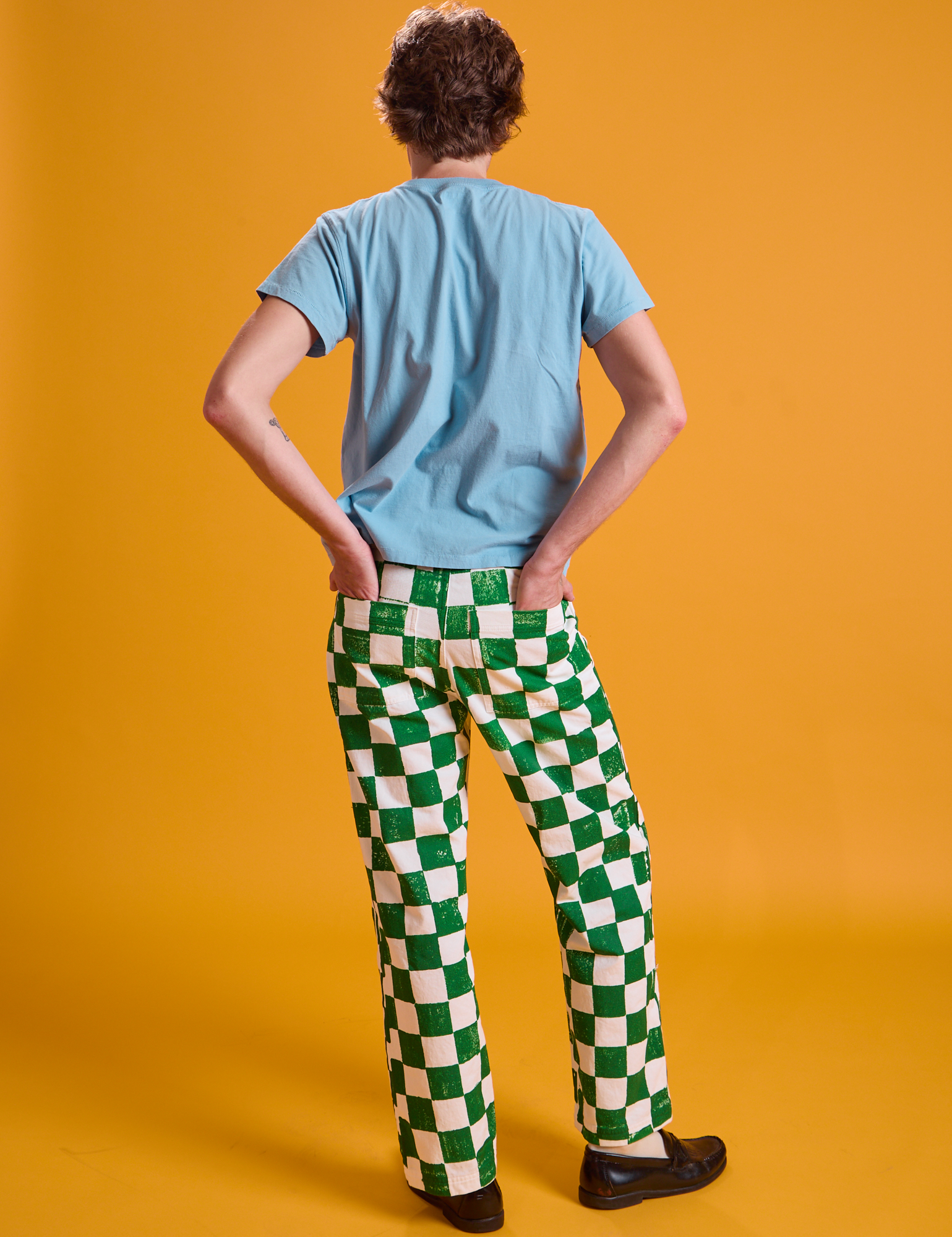 Back view of Checkerboard Work Pants in White/Green and baby blue Organic Vintage Tee on Quinn
