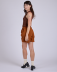 Pleated Trouser Shorts in Burnt Terracotta angled back view on Alex