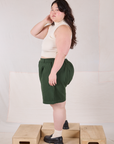 Side view of Trouser Shorts in Swamp Green and Sleeveless Turtleneck in Vintage Tee Off-White on Ashley
