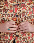 Close up of Juliet buttoning up the Hot Stuff Print Pantry Button-Up