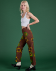 Side view of Floral Painted Work Pants in Brown and Cropped Tank in Vintage Tee White on Madeline