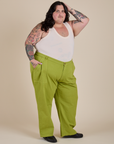 Angled front view of Work Pants in Gross Green and Cropped Tank in Vintage Tee White on Sam