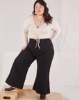 Ashley is wearing Wrap Top in Vintage Tee Off-White and black Bell Bottoms