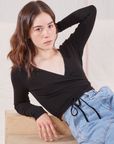 Hana is wearing Wrap Top in Basic Black
