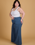 Side view of Heritage Wide Leg Trousers in French Blue and vintage tee white Cropped Tank on Ashley