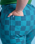 Close up of Ashley's hand in the back pocket of Checkerboard Work Pants in Blues