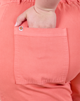 Close up of Ashley's hand in the back pocket of Classic Work Shorts in Flamingo Pink