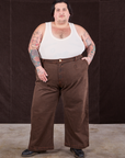 Sam is wearing Overdyed Wide Leg Trousers in Brown and Tank Top in vintage tee off-white