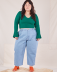 Ashley is wearing Bell Sleeve Top in Hunter Green and light wash Trouser Jeans