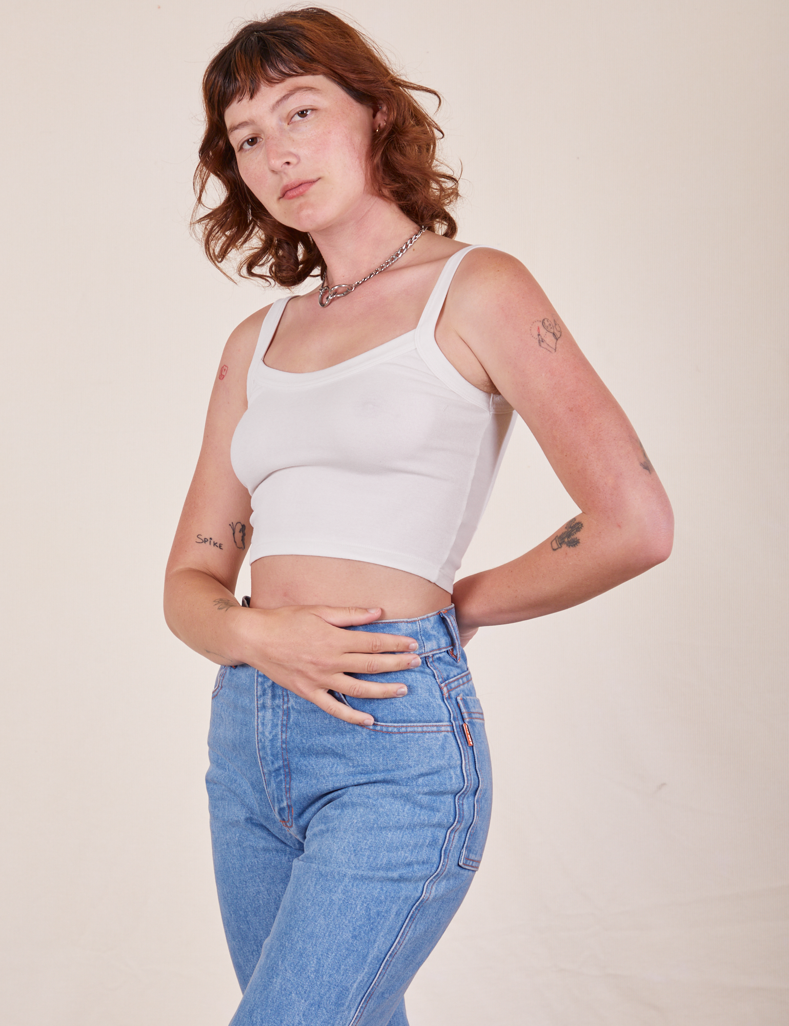 Angled view of Cropped Cami in Vintage Tee Off-White and light wash Frontier Jeans worn by Alex