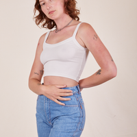 Angled view of Cropped Cami in Vintage Off-White and light wash Frontier Jeans worn by Alex