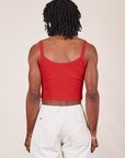 Back view of Cropped Cami in Mustang Red and vintage tee off-white Western Pants worn by Jerrod