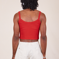 Back view of Cropped Cami in Mustang Red and vintage off-white Western Pants worn by Jerrod