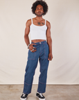 Jerrod is wearing Cropped Cami in Vintage Tee Off-White and dark wash Carpenter Jeans